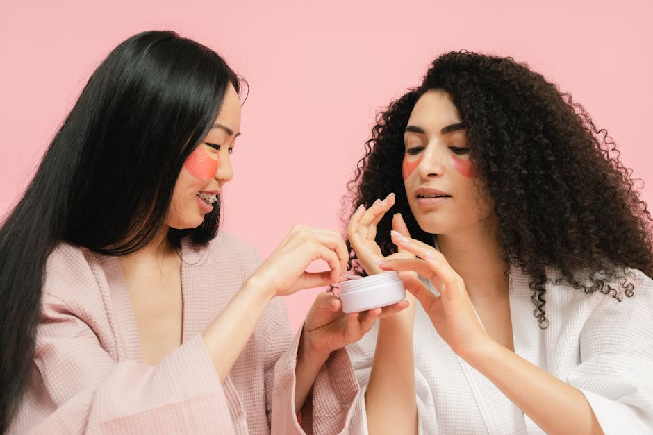 Two women with facial patches apply skincare cream, enhancing beauty and self-care routine