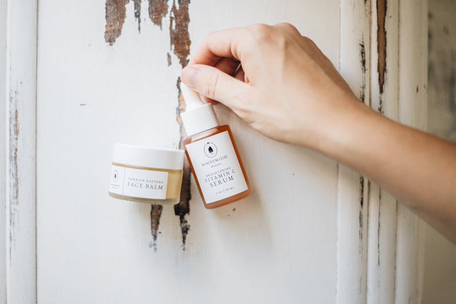 Elegant skincare display featuring face balm and vitamin C serum, showcasing minimalist beauty